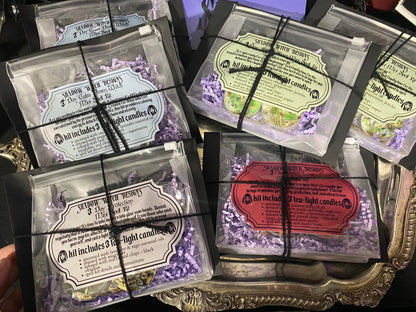 Packaged tea light candles with decorative labels on a decorative stand.